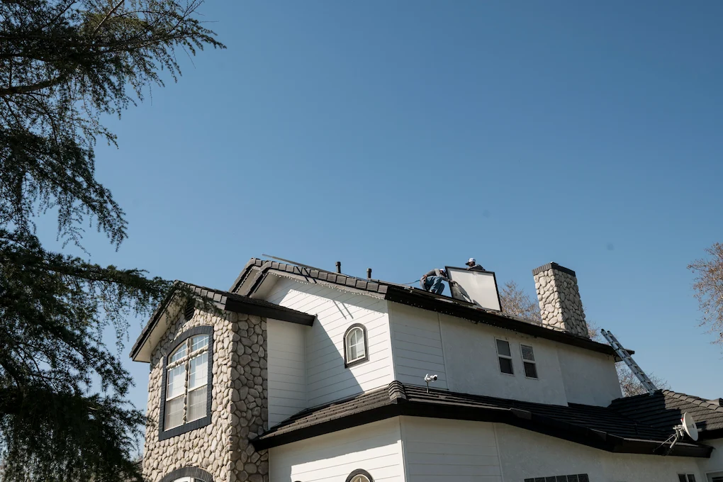 View from the ground of two installers installing solar panels