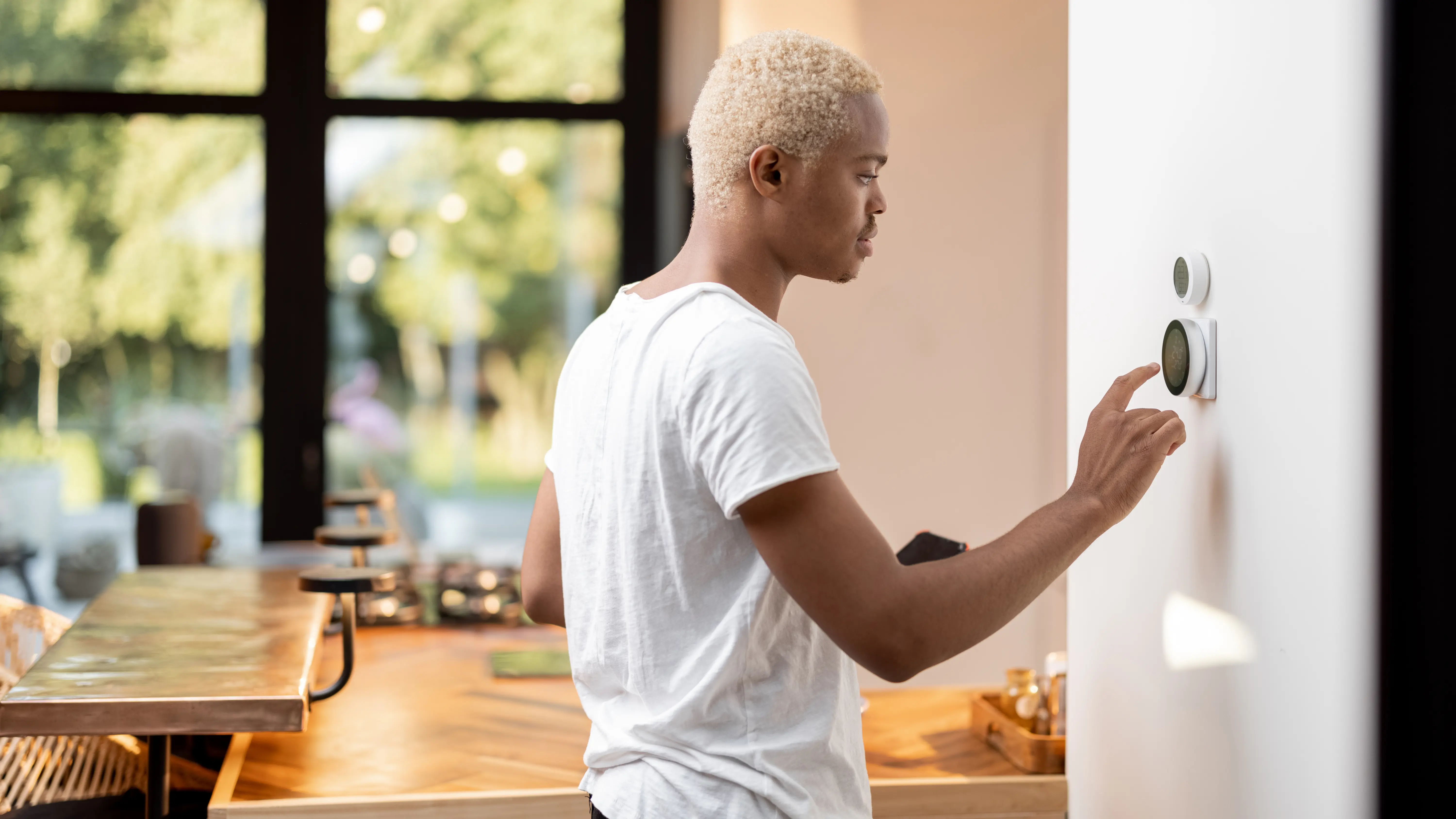 Homeowner using a smart thermostat